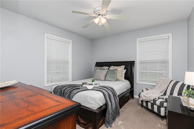 carpeted bedroom with a ceiling fan and baseboards