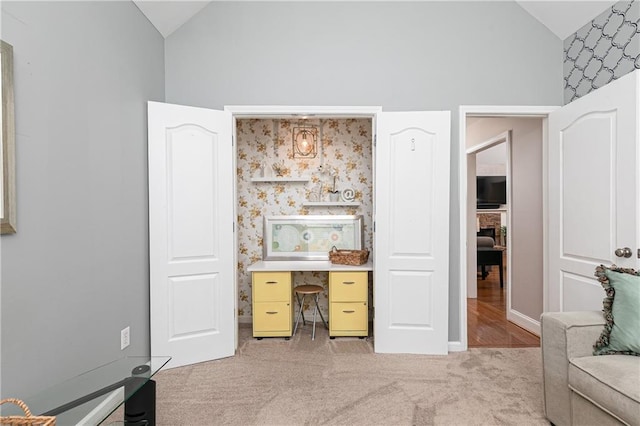 bedroom with light colored carpet and high vaulted ceiling