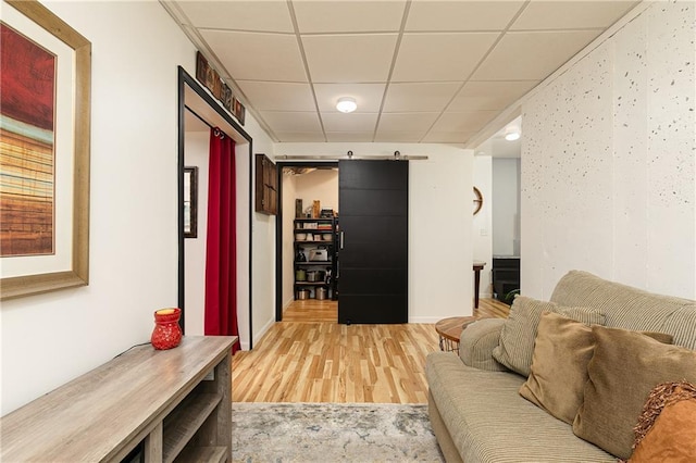 living room featuring wood finished floors and a paneled ceiling