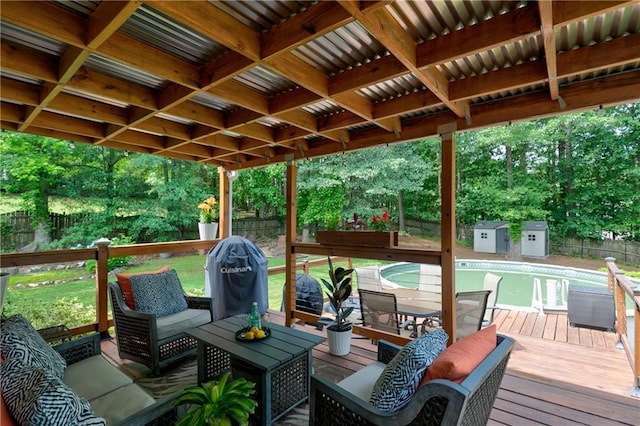 wooden terrace featuring a fenced backyard, an outdoor hangout area, and view of scattered trees