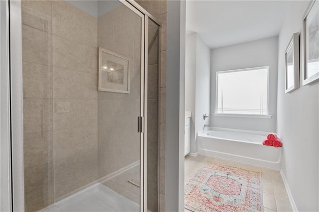 bathroom with shower with separate bathtub and tile patterned floors