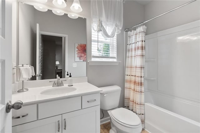 full bathroom with vanity, shower / bath combo, and toilet