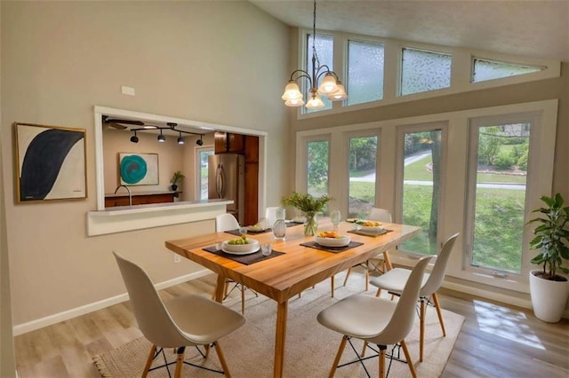 dining area with a wealth of natural light and light wood-style flooring