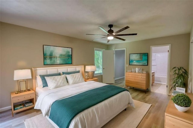 bedroom with a ceiling fan, light wood finished floors, and baseboards