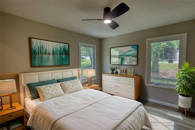 bedroom featuring wood finished floors, ceiling fan, and baseboards