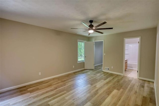 unfurnished room with baseboards, visible vents, ceiling fan, and light wood-style flooring