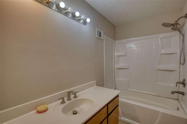 full bathroom featuring visible vents, vanity, and tub / shower combination