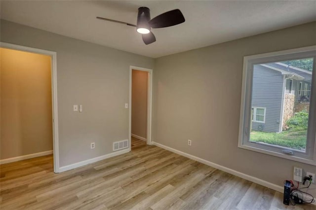 unfurnished bedroom with visible vents, baseboards, ceiling fan, and light wood-style floors