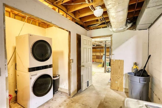 washroom featuring stacked washing maching and dryer and laundry area