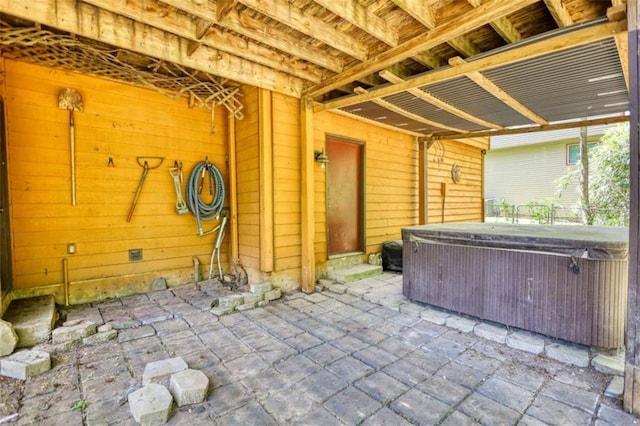 view of patio / terrace with a hot tub