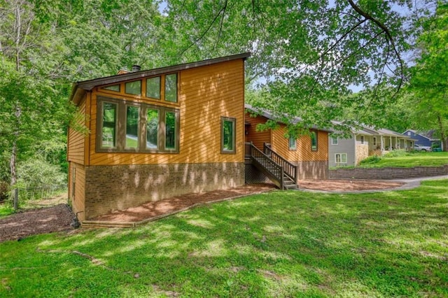 exterior space featuring a yard and a chimney