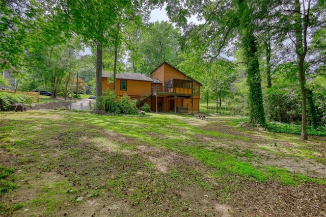 view of yard featuring a deck and stairs