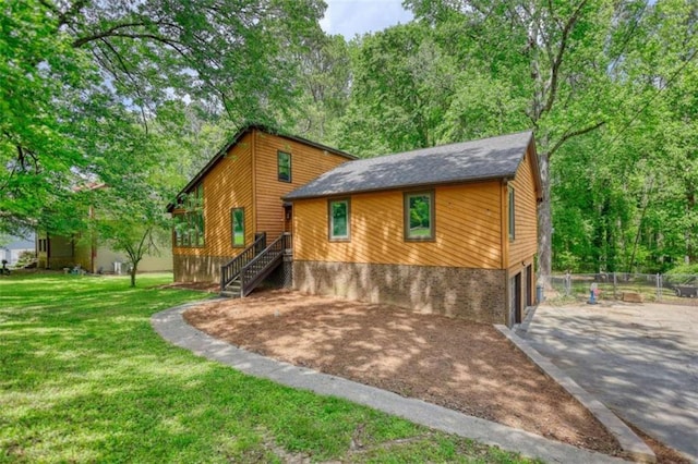 view of front of property with a front lawn, concrete driveway, and an attached garage