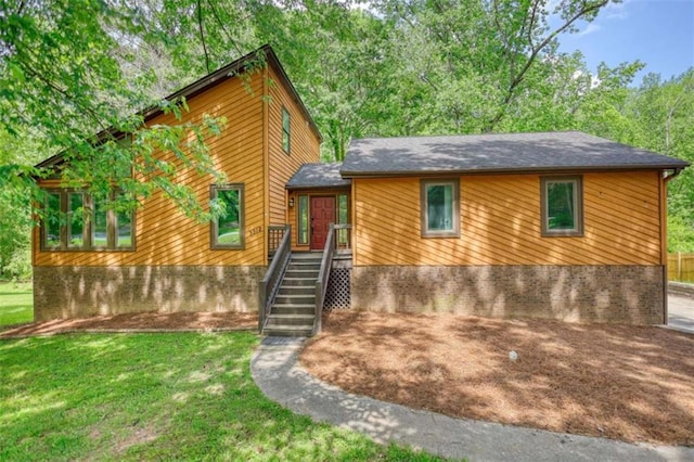 rustic home featuring a front lawn