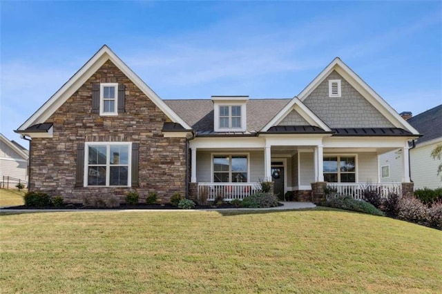 craftsman-style house featuring a front yard and covered porch