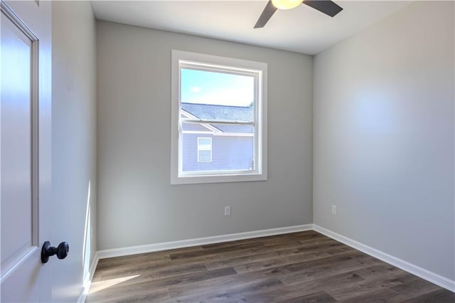 empty room with dark hardwood / wood-style floors and ceiling fan