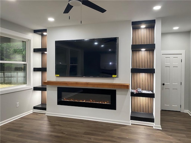 unfurnished living room with dark hardwood / wood-style floors and ceiling fan