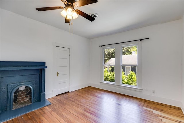 1405 May Ave SE, Atlanta, GA 30316 - unfurnished living room featuring hardwood / wood-style floors, ceiling fan, baseboards, and a fireplace with raised hearth