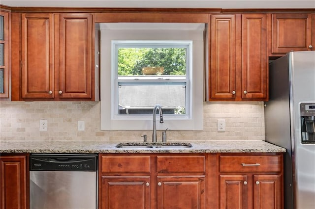 1405 May Ave SE, Atlanta, GA 30316 - kitchen with stainless steel appliances, a sink, light stone countertops, decorative backsplash, and brown cabinetry