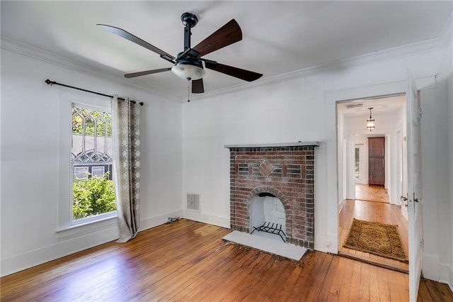 1405 May Ave SE, Atlanta, GA 30316 - unfurnished living room with hardwood / wood-style floors, crown molding, a brick fireplace, a ceiling fan, and baseboards