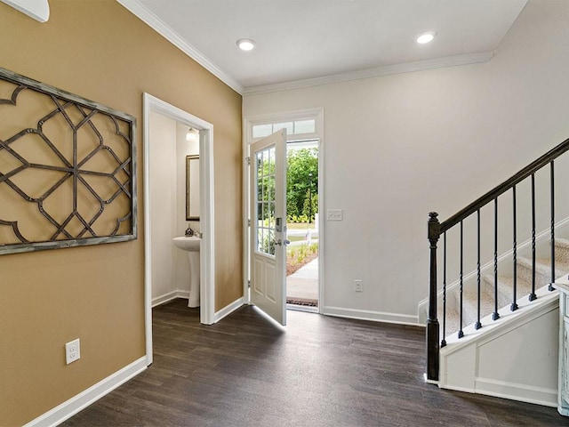 foyer featuring dark hardwood / wood-style flooring and crown molding