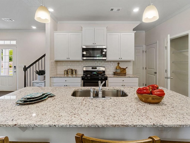 kitchen with pendant lighting, stainless steel appliances, crown molding, and a breakfast bar area