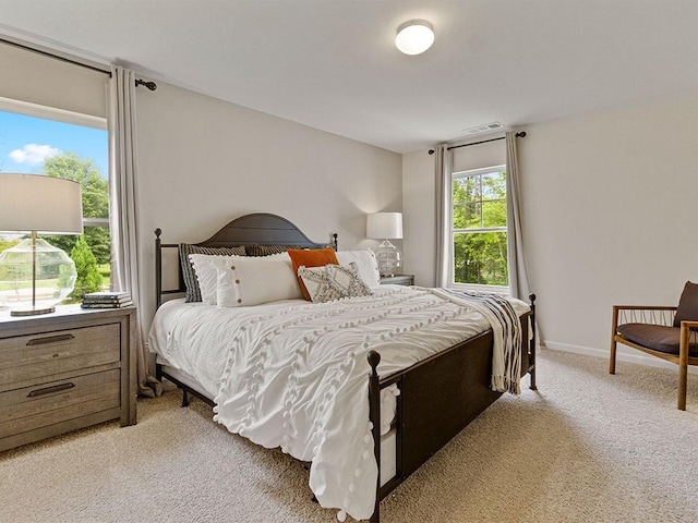 bedroom featuring light colored carpet