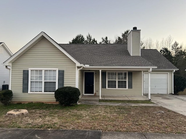 view of front of house with a garage and central AC unit