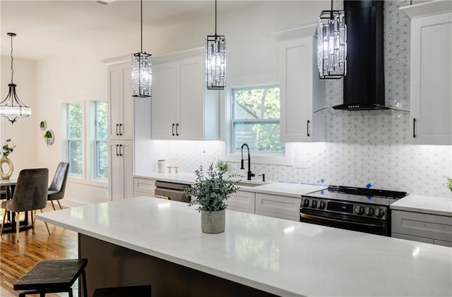 115 Dahlia Ave NW, Atlanta, GA 30314 - kitchen featuring black range with electric cooktop, ventilation hood, plenty of natural light, and a chandelier