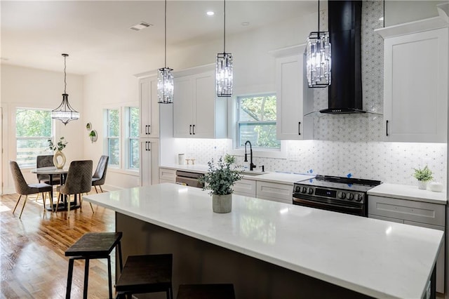 115 Dahlia Ave NW, Atlanta, GA 30314 - kitchen with range with electric cooktop, extractor fan, light wood-style flooring, healthy amount of natural light, and recessed lighting
