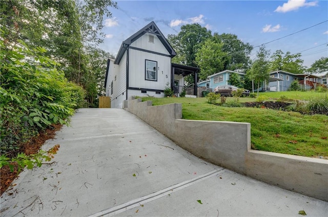 115 Dahlia Ave NW, Atlanta, GA 30314 - view of front of home with concrete driveway, a front lawn, and board and batten siding