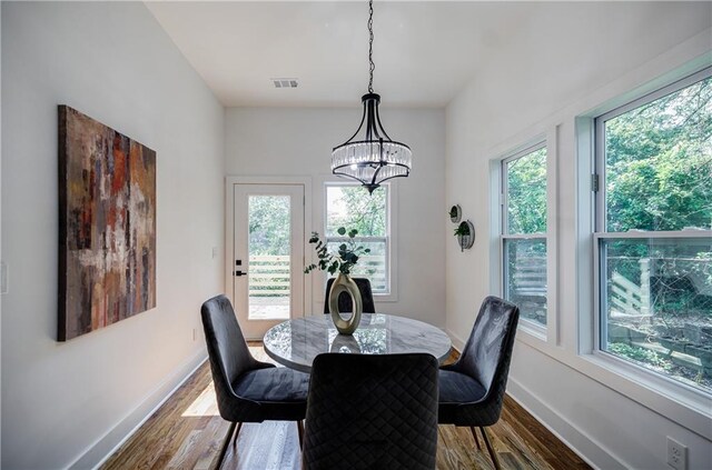 115 Dahlia Ave NW, Atlanta, GA 30314 - dining space with dark wood-style floors and a chandelier
