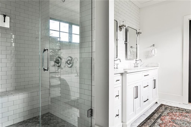 bathroom with crown molding, vanity, baseboards, and a shower stall