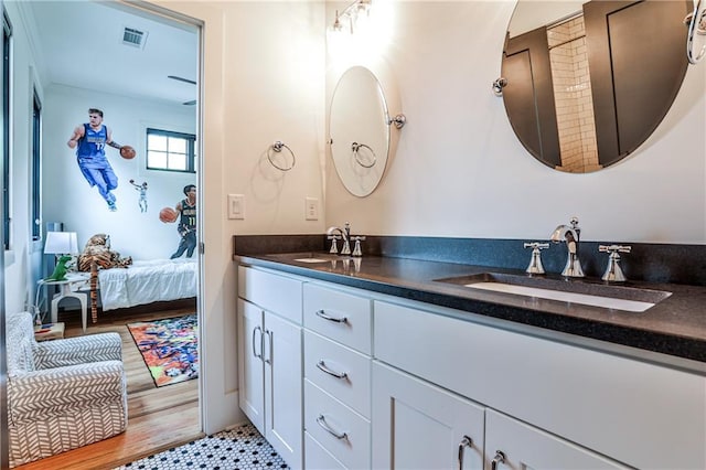 full bath with a sink, double vanity, connected bathroom, and visible vents