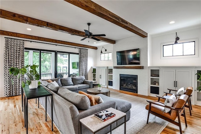living area featuring recessed lighting, a ceiling fan, light wood-style flooring, and a brick fireplace