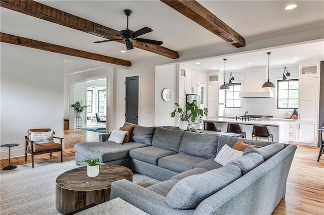 living room with recessed lighting, a ceiling fan, light wood-style floors, and beam ceiling