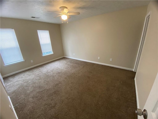 6448 Charter Way, Lithonia, GA 30058 - unfurnished room featuring ceiling fan, dark carpet, baseboards, and a textured ceiling