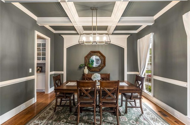 5173 Brendlynn Dr, Suwanee, GA 30024 - dining area featuring a chandelier, wood finished floors, coffered ceiling, beam ceiling, and baseboards