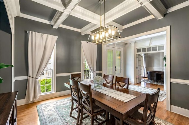 5173 Brendlynn Dr, Suwanee, GA 30024 - dining area with coffered ceiling, ornamental molding, beam ceiling, a chandelier, and light wood finished floors