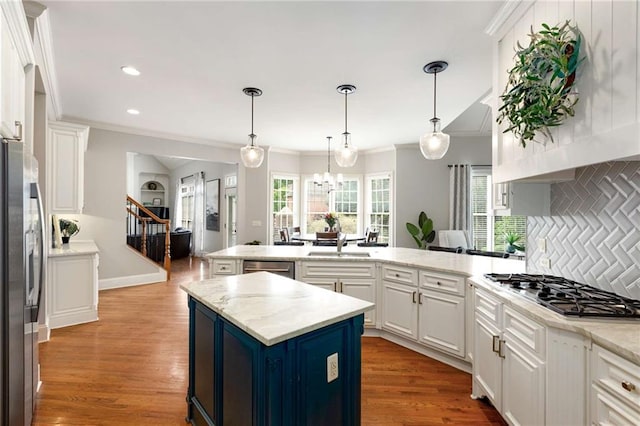 5173 Brendlynn Dr, Suwanee, GA 30024 - kitchen featuring stainless steel appliances, crown molding, a peninsula, decorative backsplash, and white cabinets