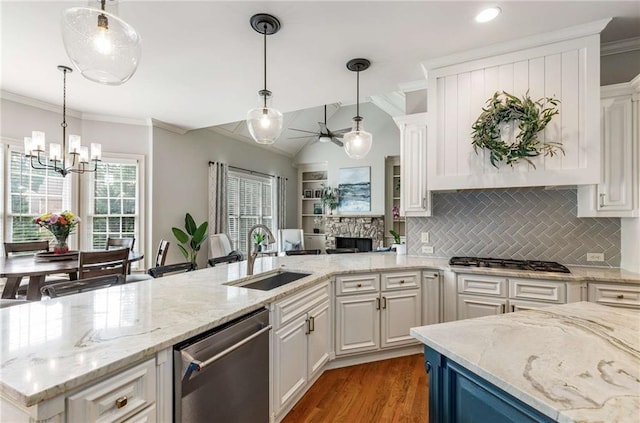 5173 Brendlynn Dr, Suwanee, GA 30024 - kitchen with stainless steel appliances, a sink, a chandelier, white cabinets, and backsplash