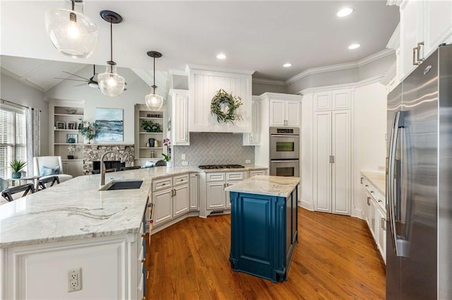 5173 Brendlynn Dr, Suwanee, GA 30024 - kitchen with appliances with stainless steel finishes, a sink, white cabinetry, wood finished floors, and a ceiling fan
