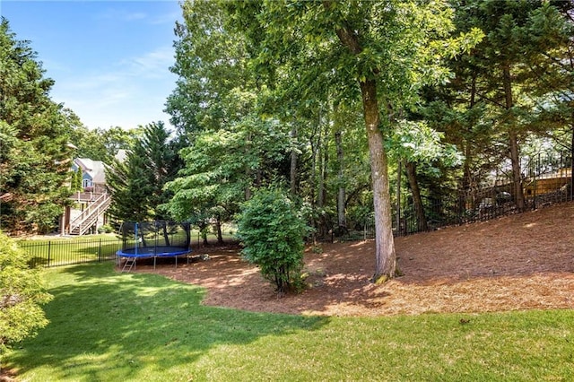 5173 Brendlynn Dr, Suwanee, GA 30024 - view of yard featuring a trampoline