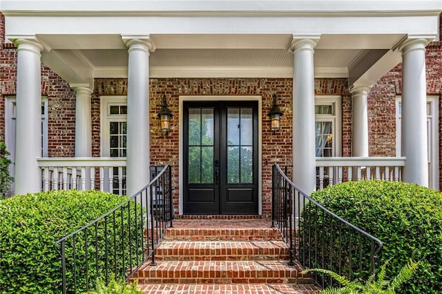 5173 Brendlynn Dr, Suwanee, GA 30024 - entrance to property featuring brick siding, french doors, and a porch