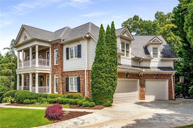 5173 Brendlynn Dr, Suwanee, GA 30024 - view of front facade with a garage, a balcony, brick siding, driveway, and a shingled roof