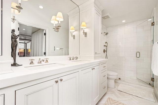 2575 Peachtree Rd NE Unit 8D, Atlanta, GA 30305 - bathroom with a shower stall, double vanity, recessed lighting, and toilet