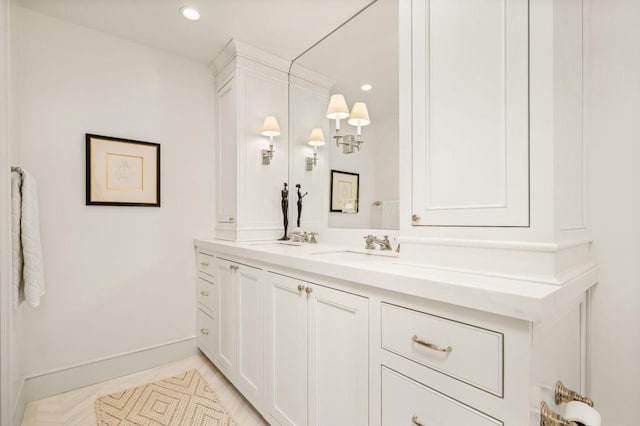 bathroom with recessed lighting, vanity, and baseboards