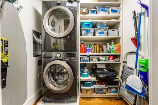 2575 Peachtree Rd NE Unit 8D, Atlanta, GA 30305 - washroom featuring stacked washer and clothes dryer and wood finished floors