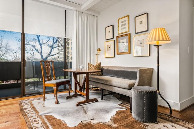 2575 Peachtree Rd NE Unit 8D, Atlanta, GA 30305 - living area featuring beam ceiling, wood finished floors, a wall of windows, and baseboards