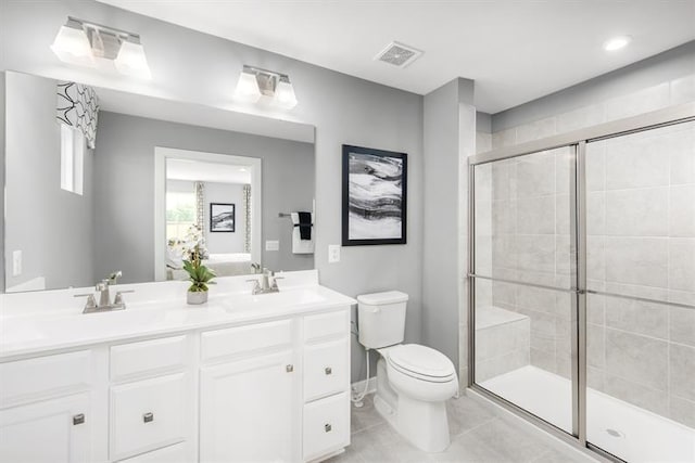 bathroom featuring a shower stall, toilet, visible vents, and a sink